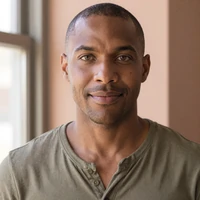 Eli, a Black American veteran in his late thirties, smiling softly in warm window light